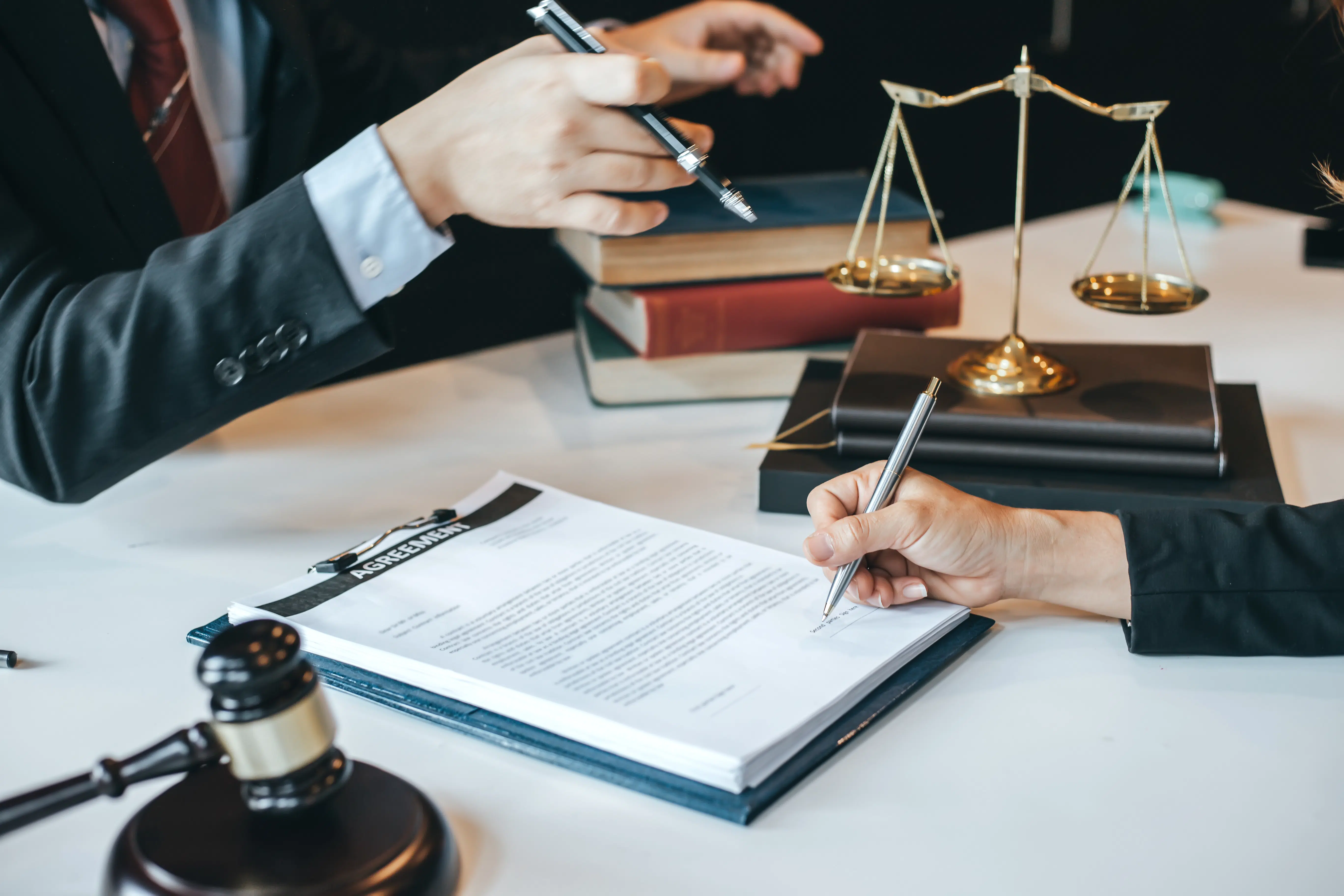 Close-up of a calculator on top of financial documents, representing wage calculations and employer record-keeping requirements.